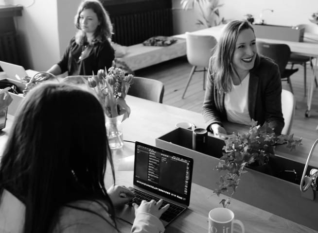 a group of people discussing some stuff and working together